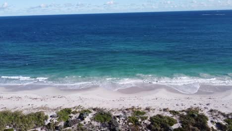 indian ocean waves at quinns beach, aerial tilt down view over former quinns rocks caravan site