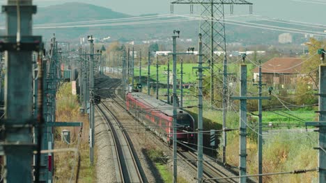 a high-speed train running through an industrial area in austria