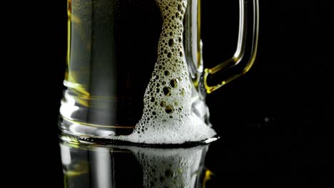 Mug-of-beer-against-black-background-4k