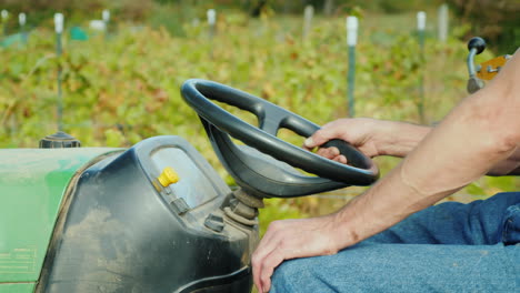 Man-Driving-Tractor-in-Vineyard