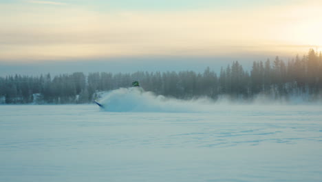 energetic snowmobile driver speeding across snowy lapland woodland at sunrise