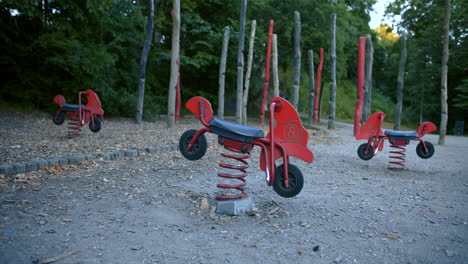 empty playground swings swinging