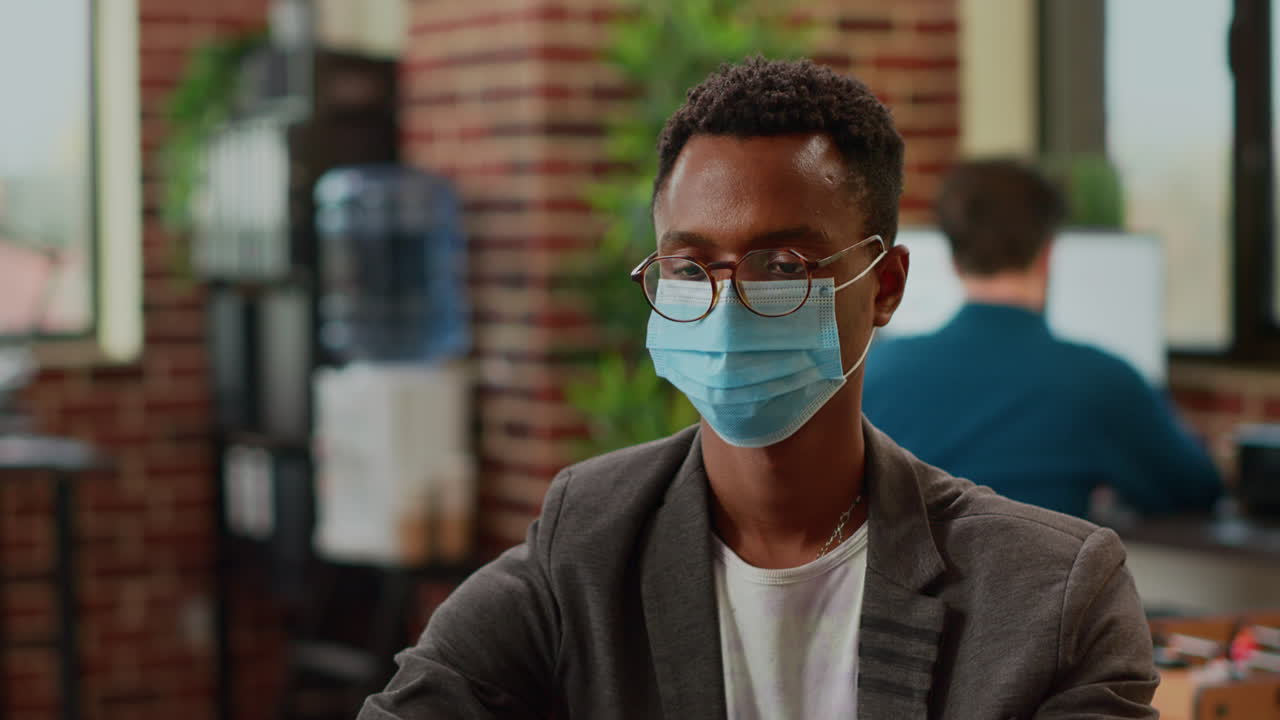 African american employee analyzing information on laptop