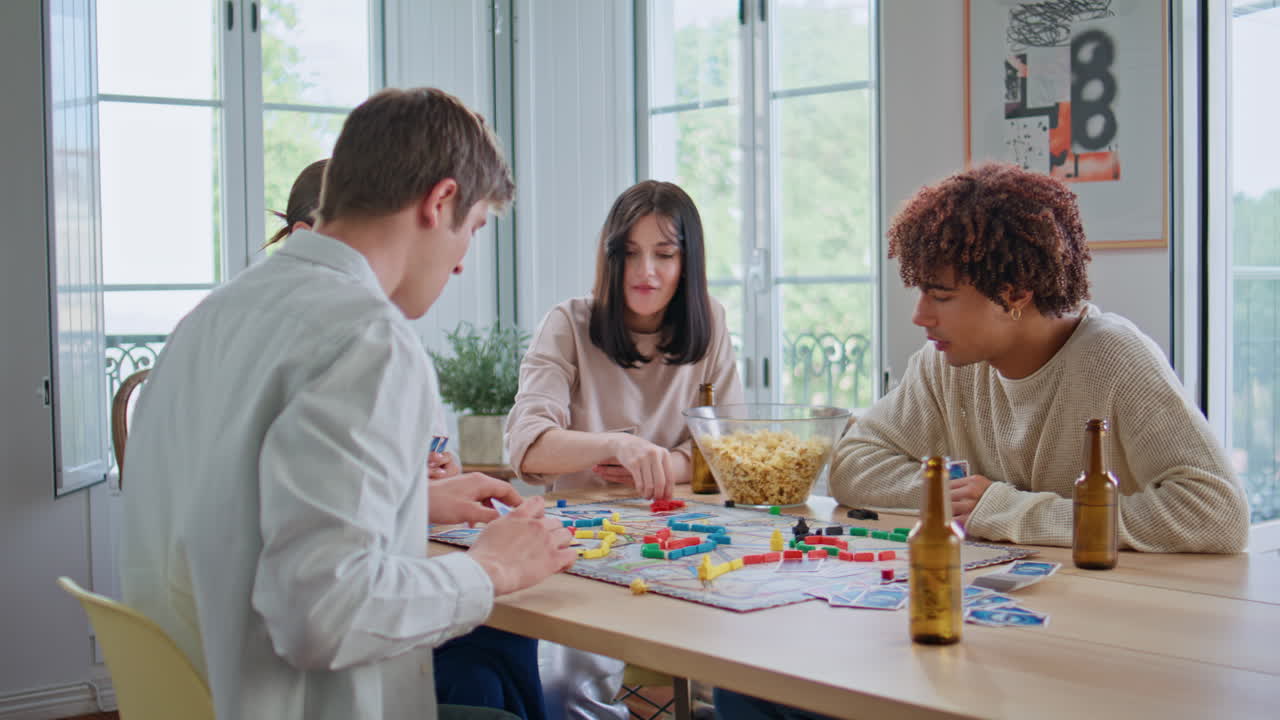 Group buddies playing table game at home closeup. Friends enjoying playtime