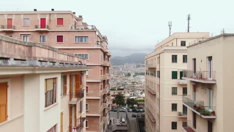 Genoa-city-apartment-buildings-and-cityscape,-close-up-drone-ascend-view