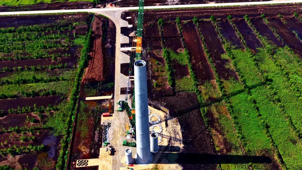 Wind farm turbine under construction, green energy electricity production field, aerial