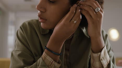 woman putting in hearing aid