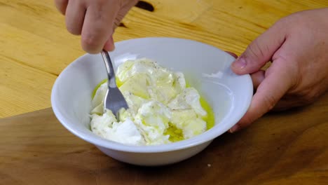 the chef mixing yogurt, sauce and cheese