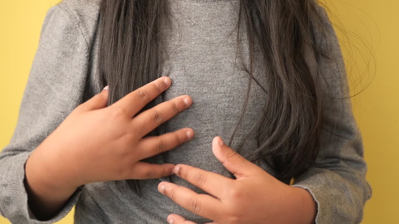 Close-up of a girl touching her chest