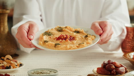 woman serving a middle eastern dish