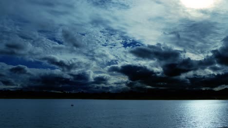 time lapse of a dramatic sky at dusk, with normal speed for the lake