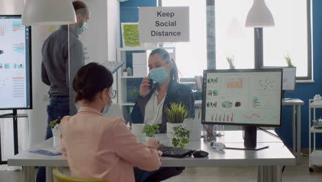 freelancers with protection face masks working in new normal business office