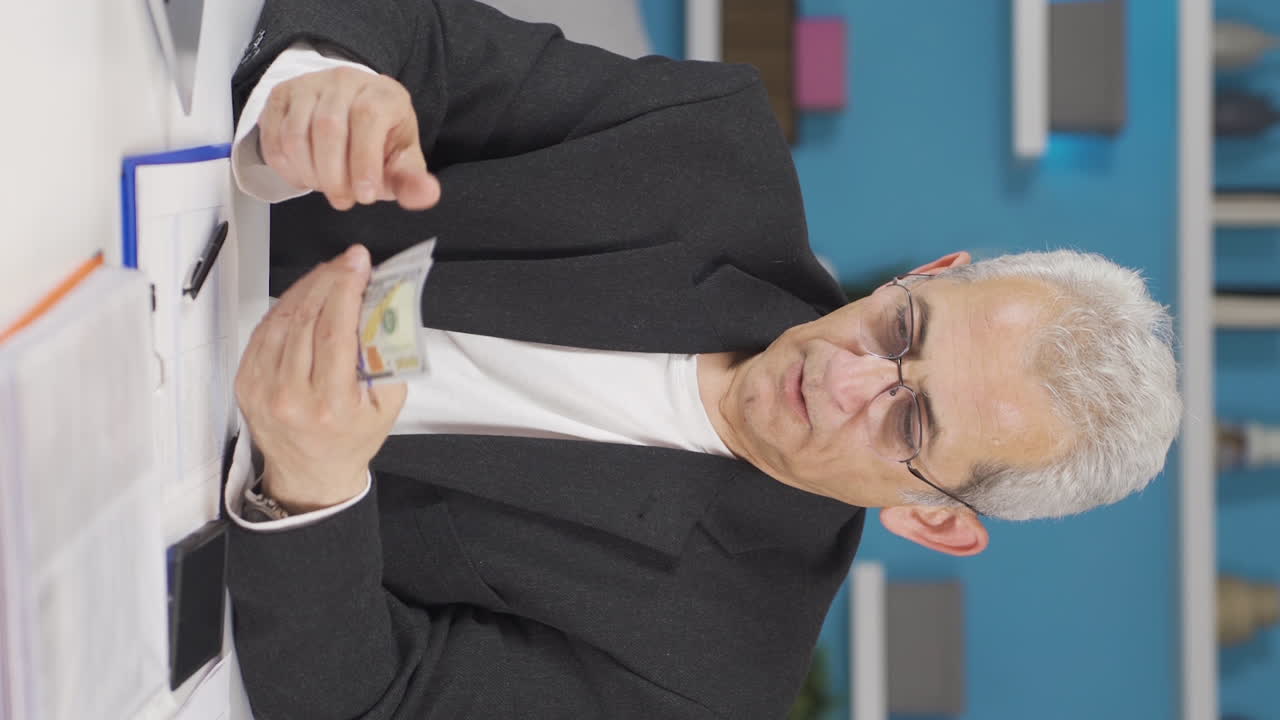 Vertical video of Home office worker man making money and feeling happy.