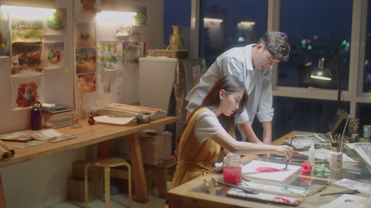 Teacher Giving Painting Class to Young Female Student