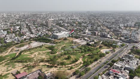 drone circling above jaipur’s indian flag in the middle of road network