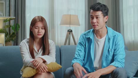 couple arguing on sofa