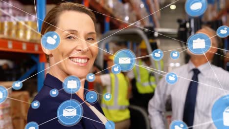 Animation-of-network-of-digital-icons-against-caucasian-female-supervisor-smiling-at-warehouse