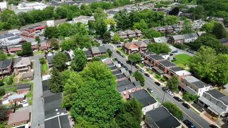 townhouse in american neighborhood. aerial flyover shot. historic american two story homes. wide shot. green trees in district.
