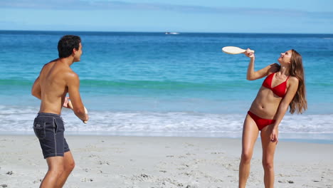 cheerful couple playing with paddles