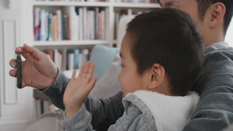 asian father and child using smartphone having video chat little boy waving sharing weekend with with dad enjoying chatting on mobile phone to friend 4k