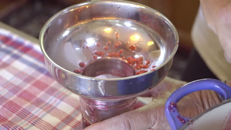 raspberry preserve ladled into jar for jelly