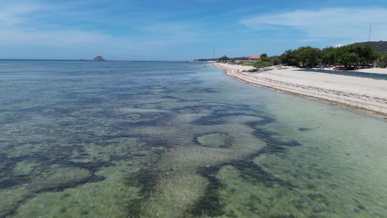 Aerial zoom out of "My Hoa" Lagoon in Phan Rang, Vietnam, expanding from shallow waters to a broad coastal landscape.