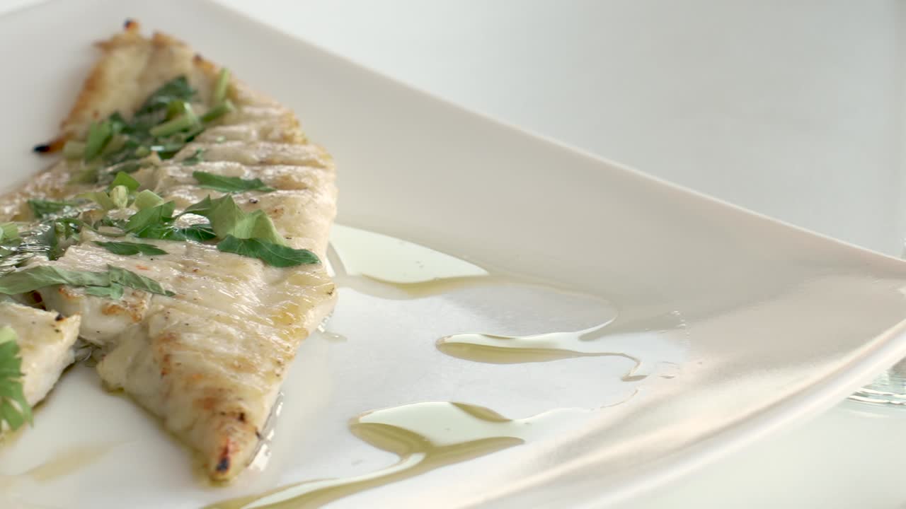 Savoring a culinary masterpiece complemented by a crisp glass of wine at a modern dining setting