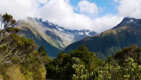 pan-of-forested-mountainside-and-clouded-mountains