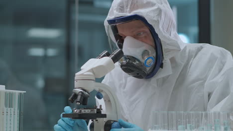 virologist is researching new virus covid-19 in medical laboratory wearing protective overall and respirator for saving health portrait of health professional