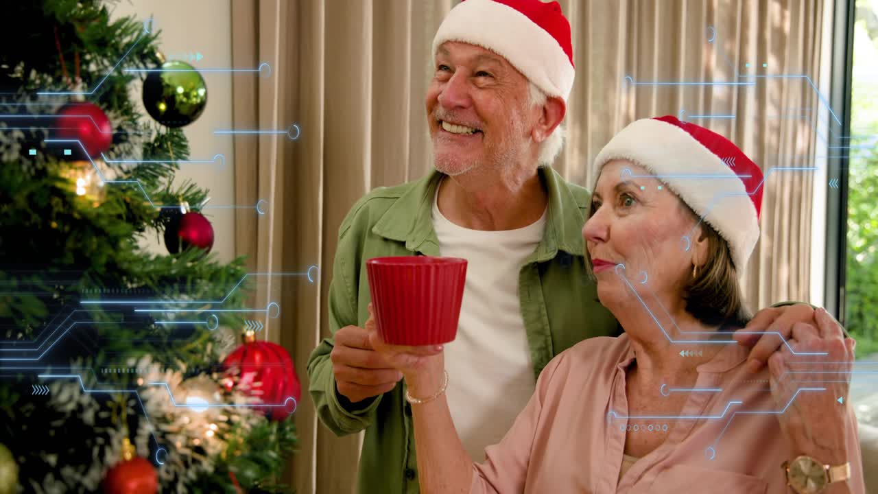 Senior couple by Xmas tree, man reaching ornament initiating joy, woman sipping red mug blue HUD
