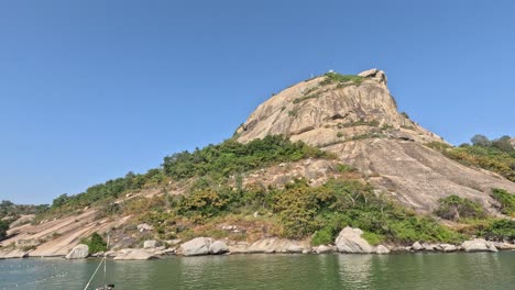 boats moving near a large mountain by water