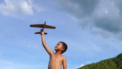 boy playing with a paper airplane