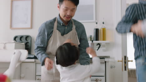 happy asian family dancing in kitchen father enjoying dance with daughter little girl laughing enjoying exciting weekend at home 4k footage