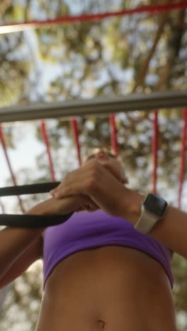 woman exercising with resistance straps outdoors