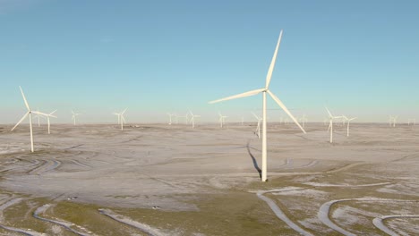 Aerial-shots-of-wind-turbines-on-a-cold-winter-afternoon-in-Calhan,-Colorado