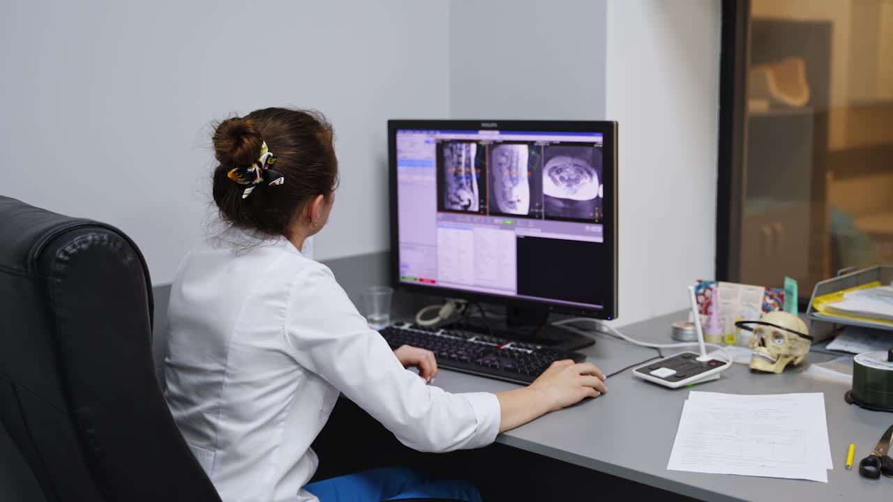 Doctor reviewing medical images on a computer in a medical office