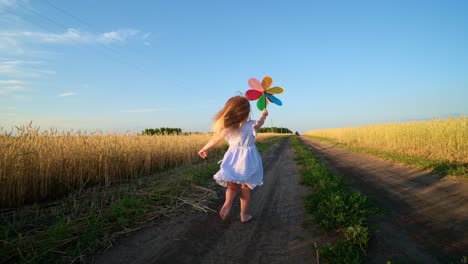 happy child running in a wheat field