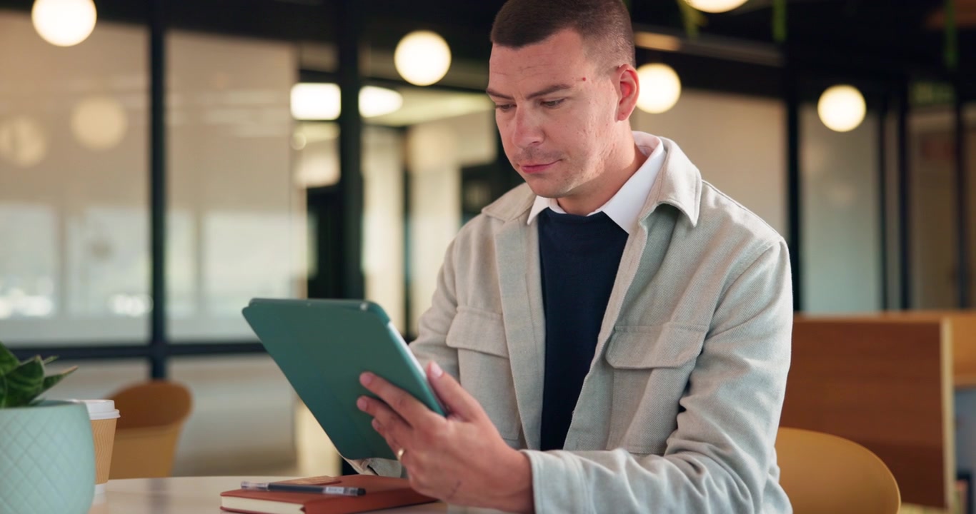 Man Using Tablet Computer in Modern Office Workspace
