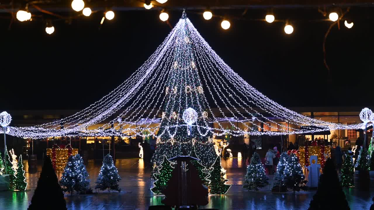 Chisinau, Moldova - December 12, 2021: People walking through the Christmas Market in the evening