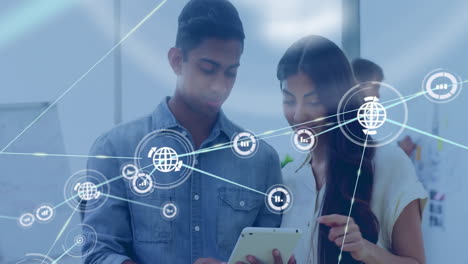 using tablet with network connections, diverse professionals processing data together