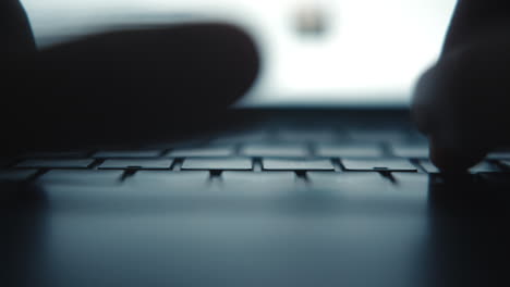 person typing on a laptop keyboard