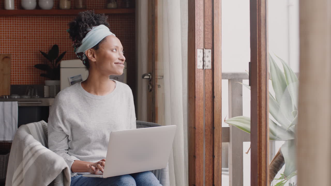 young woman using laptop computer working from home student brainstorming ideas researching information online relaxing enjoying study