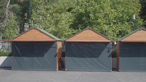 closed market stalls with wooden roofs