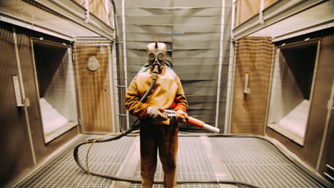 Worker-in-chemical-rubber-suit-and-respirator-in-chemical-processing-plant