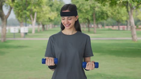 Happy-Indian-girl-lifting-dumbbells