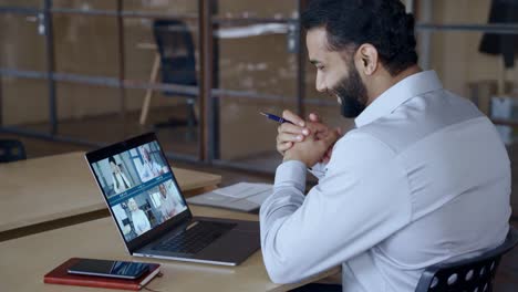 indian manager leading videoconference with team business people on computer.