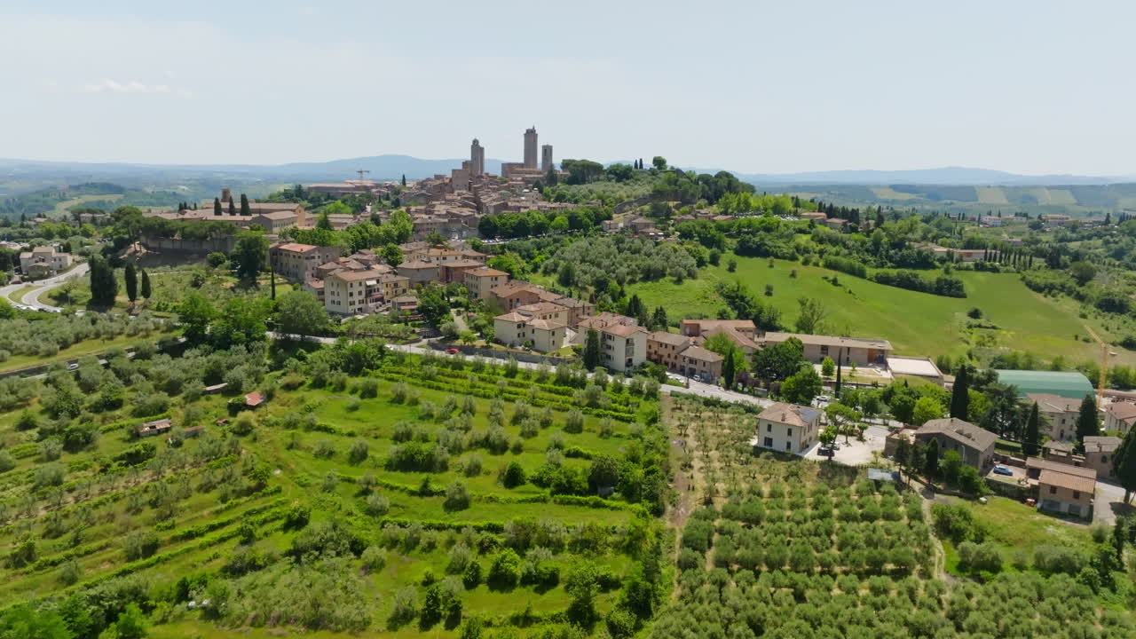 Aerial view rising in front of the San Gimignano town, in sunny Tuscany, Italy