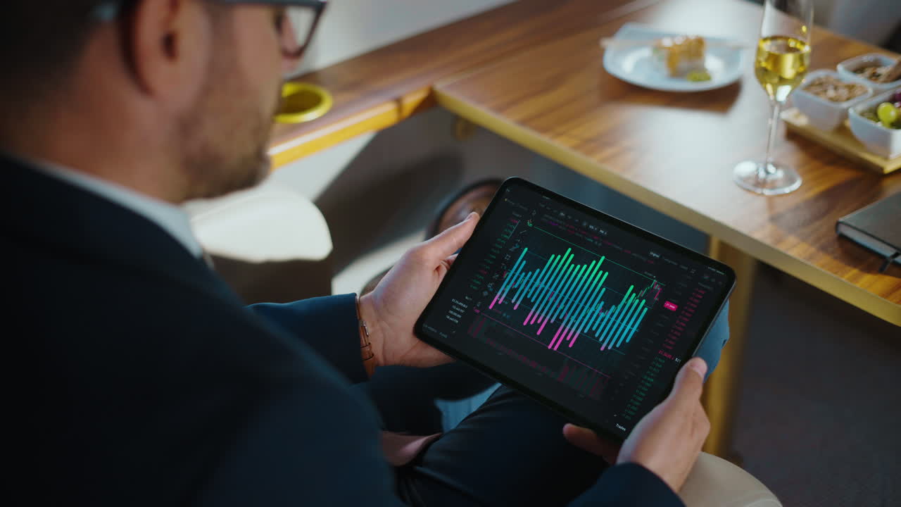 Man analyzing stock market data on tablet
