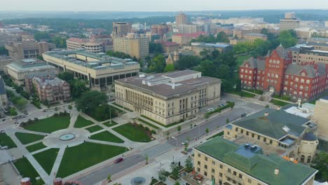 aerial, historical building and green square in city, soft light, rotating shot