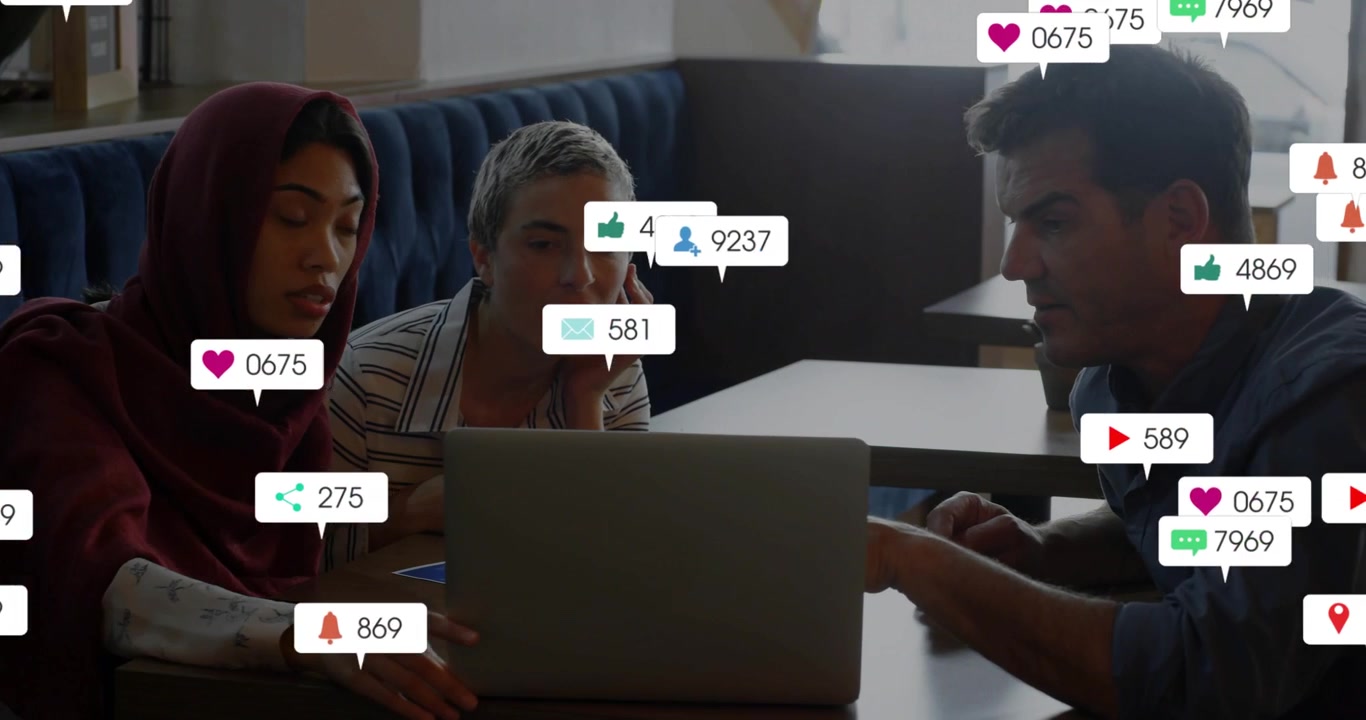 Woman in scarf tapping laptop team analyzing as social icons building showing engagement rising
